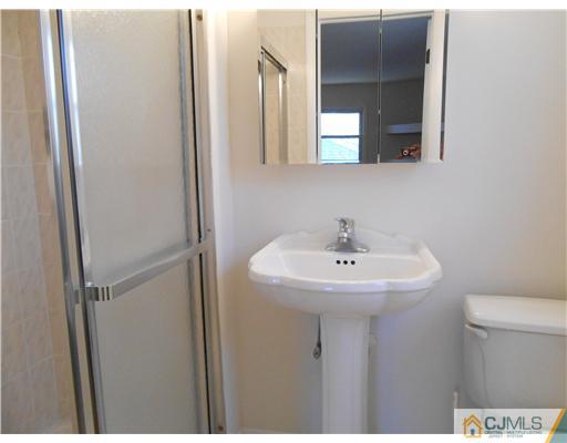 8 Nottingham Road Edison, NJ 08820 - Photo 8 of 15 a bathroom with a sink and a toilet