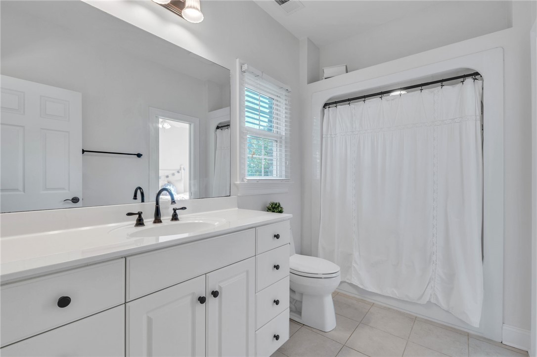 102 Country Walk Lane Clemson, SC 29631 - Photo 26 of 39 A well-lit bathroom with pristine white cabinetry, a single basin sink, and ample counter space.