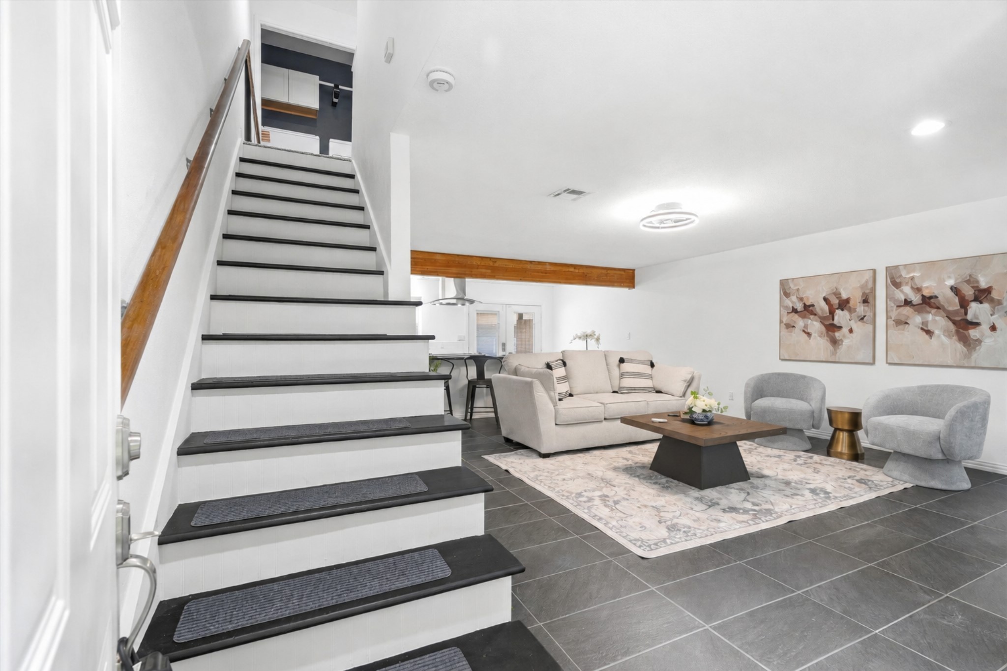 1011 Hamblen Road, Unit 306 Houston, TX 77339 - Photo 4 of 38 Right from the door, the space opens up into the living area, with a sleek staircase rising just ahead and natural light leading you further inside.