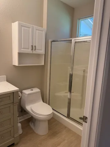 a white toilet sitting next to a bathroom sink