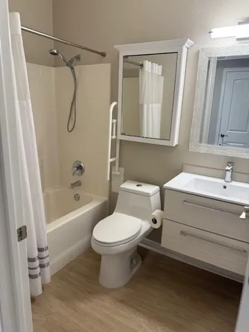 a bathroom with a sink toilet and shower