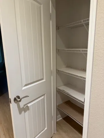 a group of people sitting in a big yard with a house