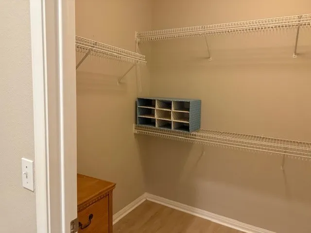 a view of a room with wooden floor and windows