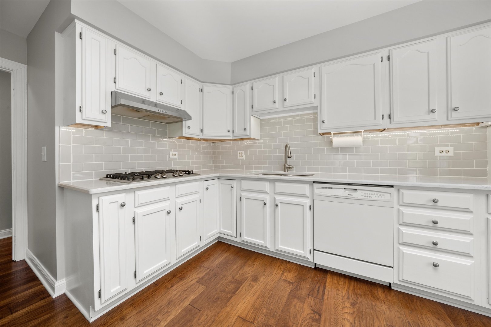 10620 Golf Road Orland Park, IL 60462 - Photo 11 of 42 a kitchen with granite countertop white cabinets white appliances and granite counter tops