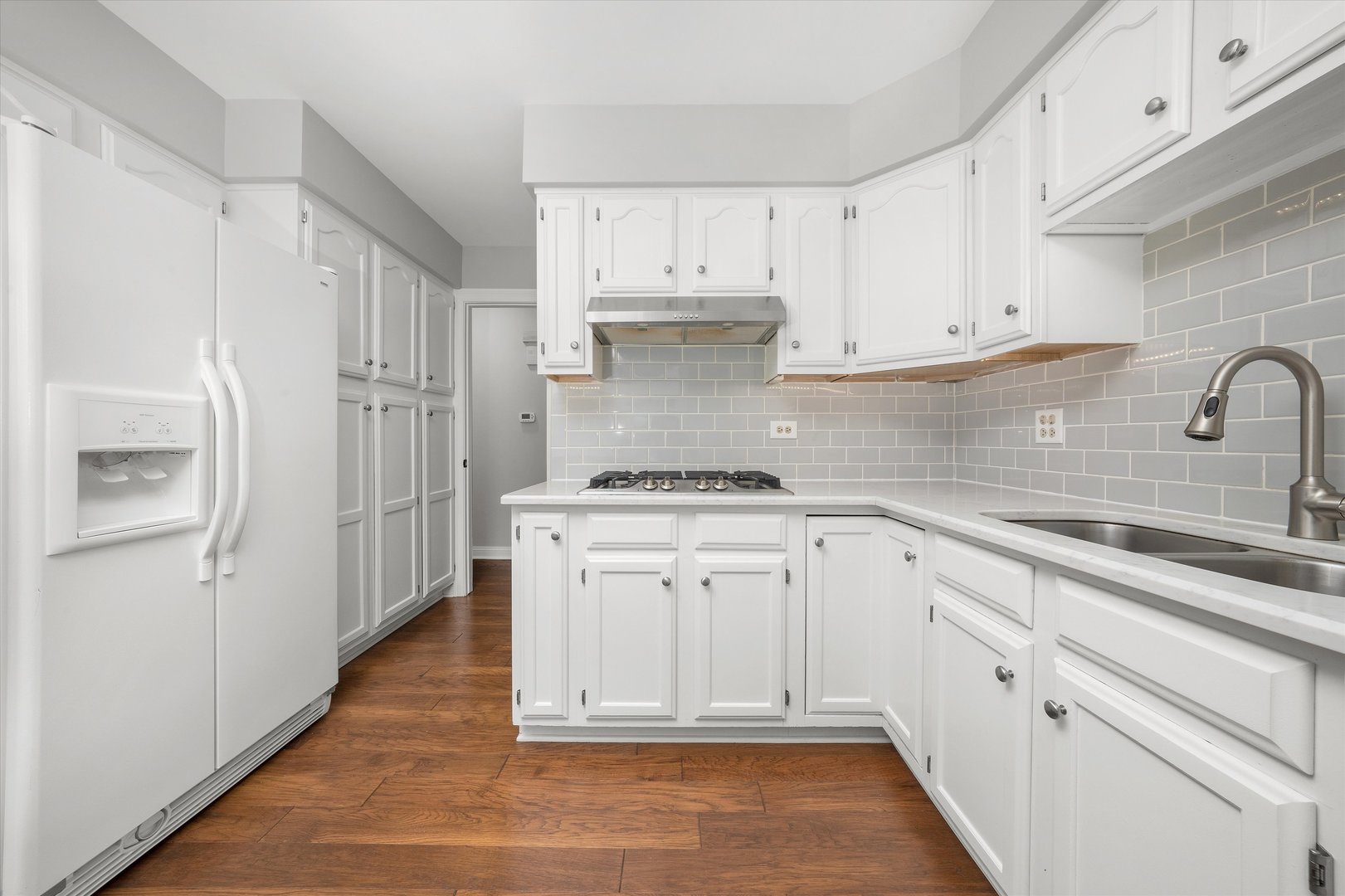 10620 Golf Road Orland Park, IL 60462 - Photo 12 of 42 a kitchen with white cabinets a sink stove and refrigerator