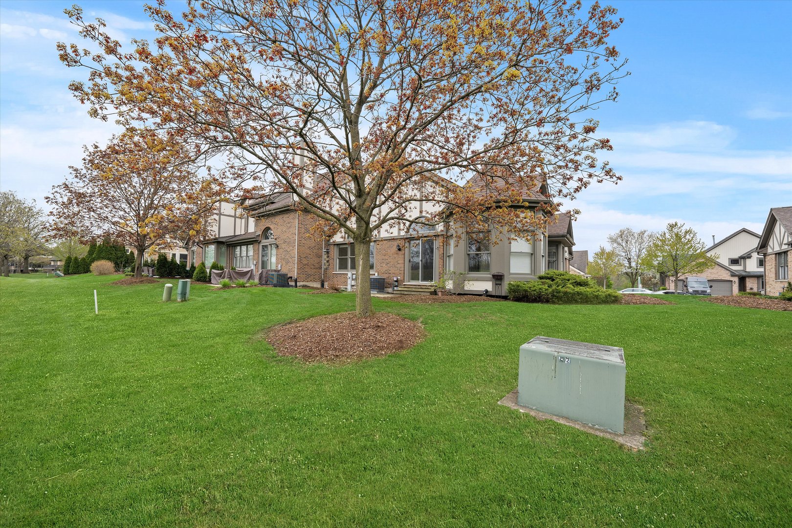 10620 Golf Road Orland Park, IL 60462 - Photo 35 of 42 a view of a white house with a yard and large trees