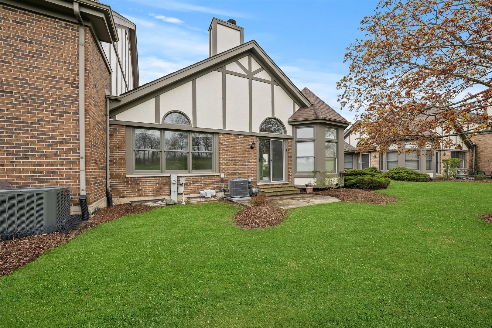 10620 Golf Road Orland Park, IL 60462 - Photo 37 of 42 a front view of a house with a yard and outdoor seating