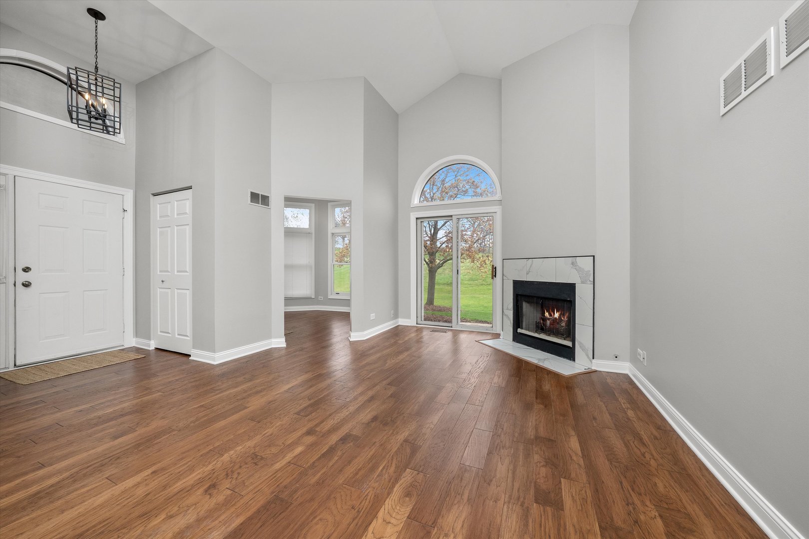 10620 Golf Road Orland Park, IL 60462 - Photo 5 of 42 a view of empty room with a fireplace and wooden floor