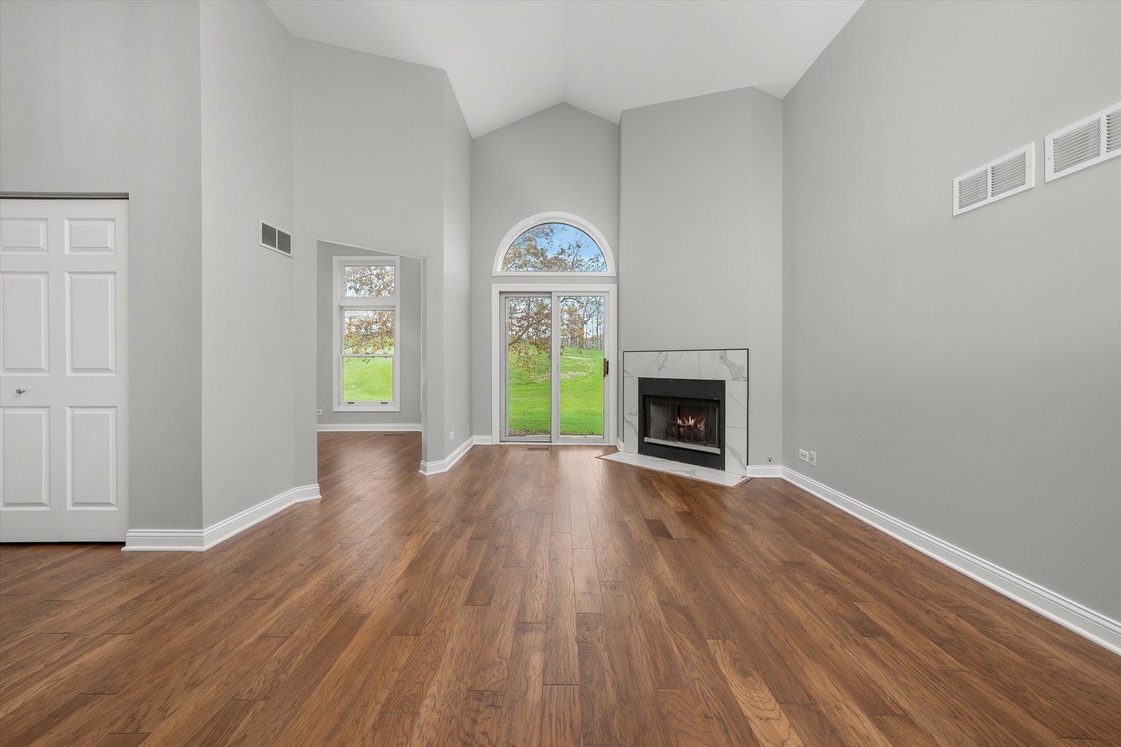 10620 Golf Road Orland Park, IL 60462 - Photo 6 of 42 a view of empty room with wooden floor and fireplace