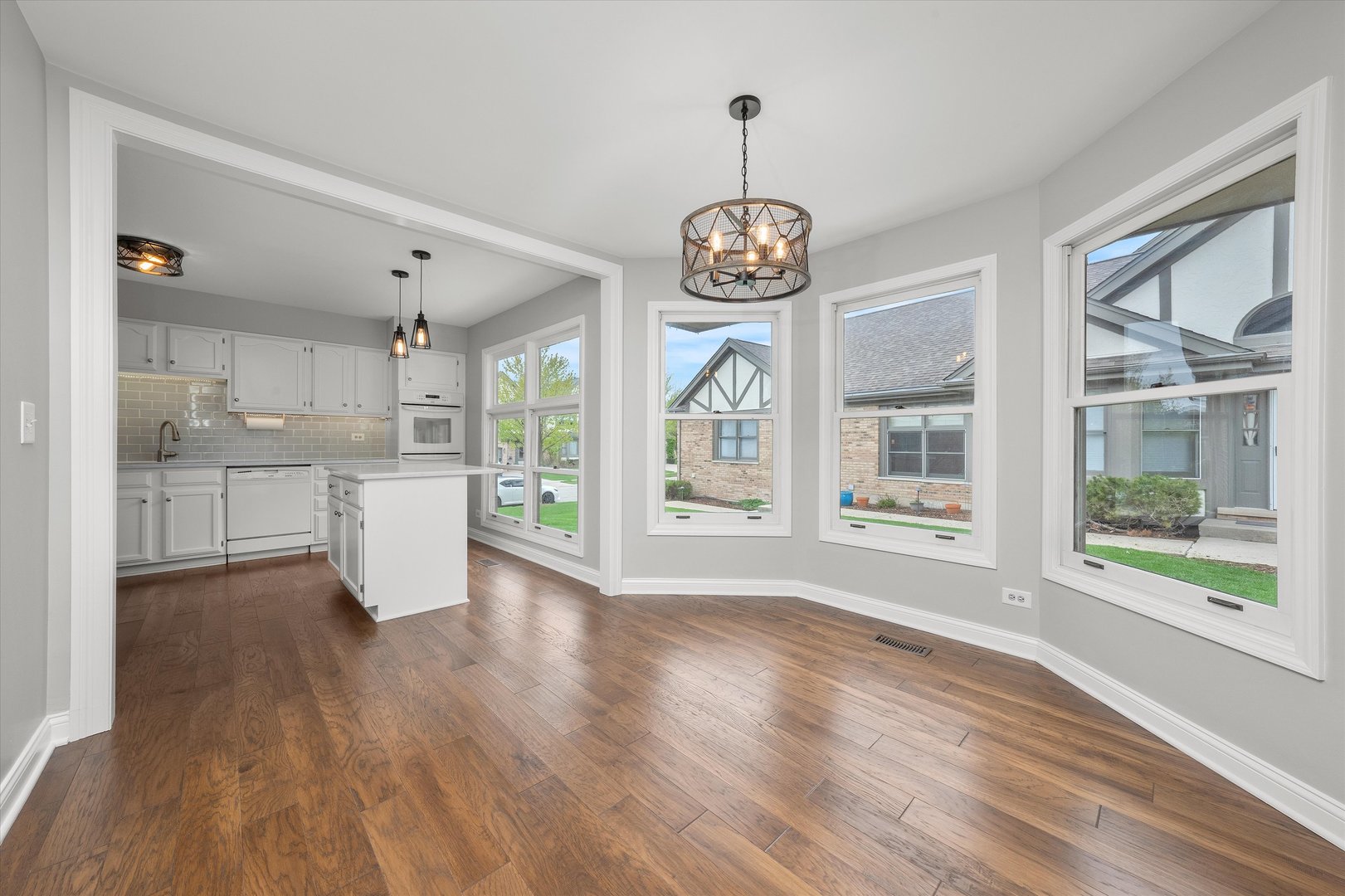 10620 Golf Road Orland Park, IL 60462 - Photo 9 of 42 a view of an empty room with wooden floor and a window