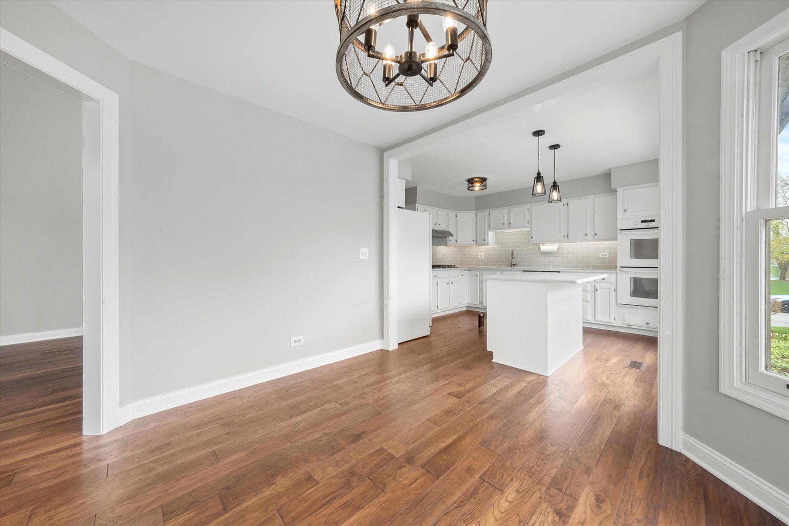 10620 Golf Road Orland Park, IL 60462 - Photo 10 of 42 a view of a kitchen with a sink and wooden floor