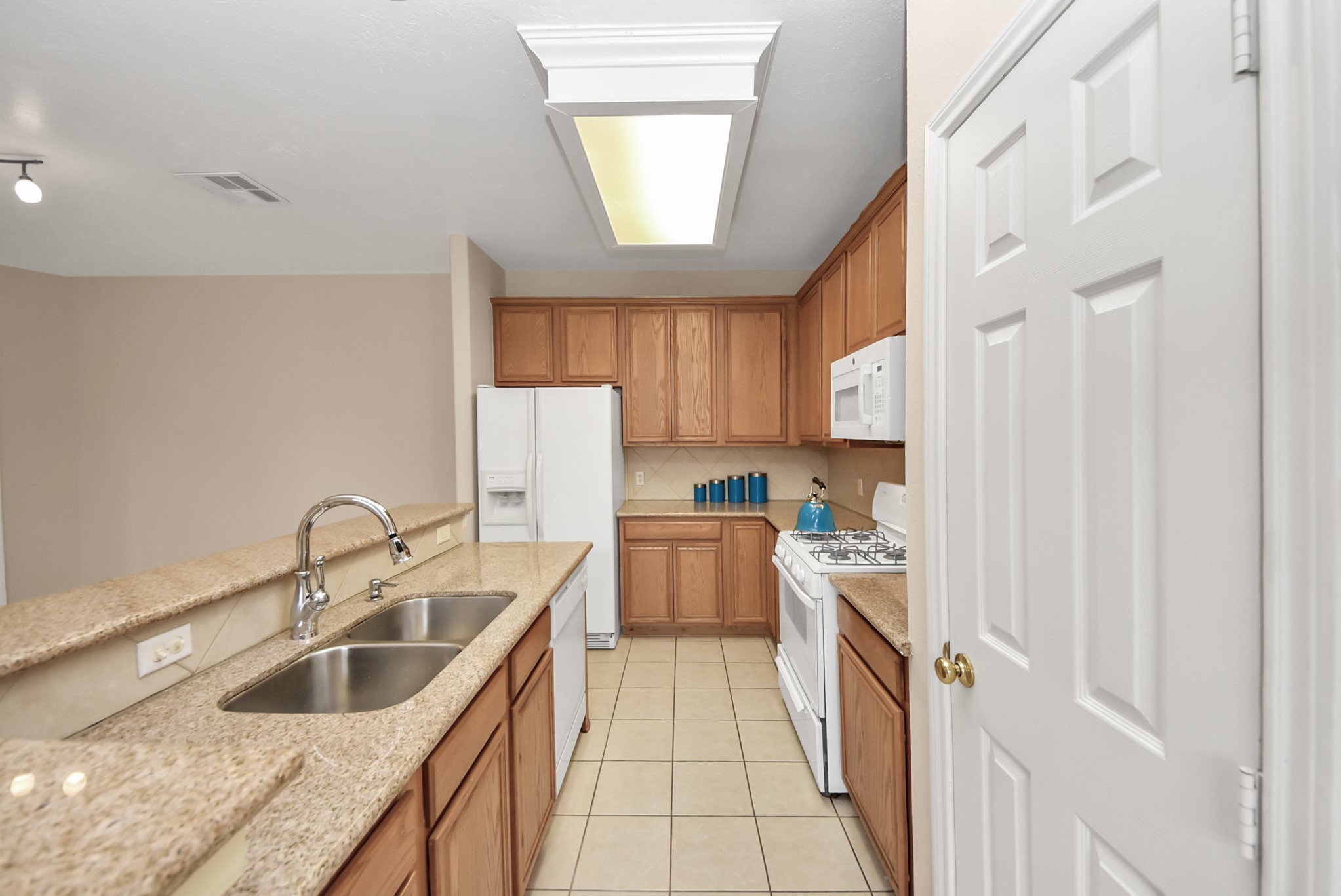18963 Candlelight Crescent Road Spring, TX 77388 - Photo 14 of 33 Kitchen island featuring granite countertops and double sinks.