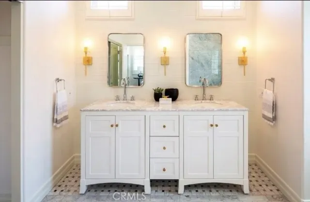 a bathroom with a double vanity sink and mirror