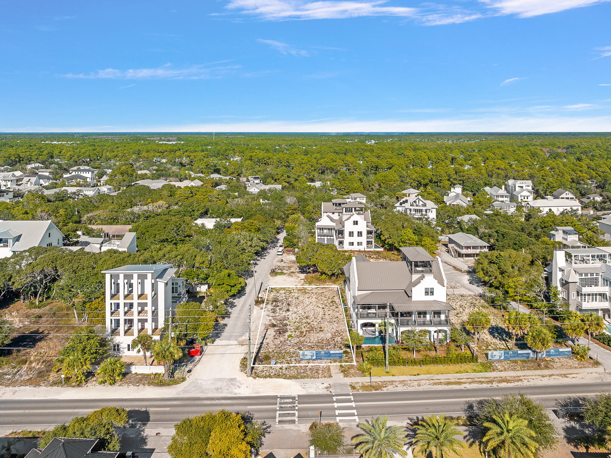 an aerial view of residential houses with outdoor space and swimming pool