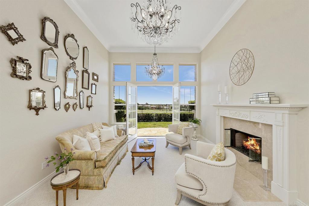 1435 Ravean Court Encinitas, CA 92024 - Photo 26 of 48 a living room with furniture a fireplace and a chandelier