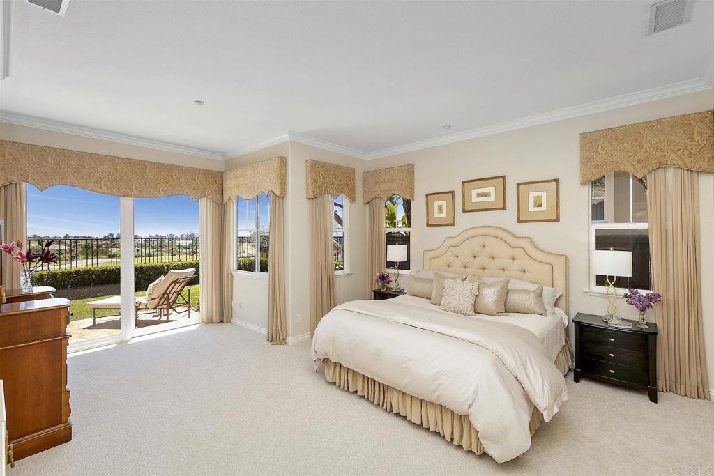 1435 Ravean Court Encinitas, CA 92024 - Photo 28 of 48 a bedroom with a large bed and a large window