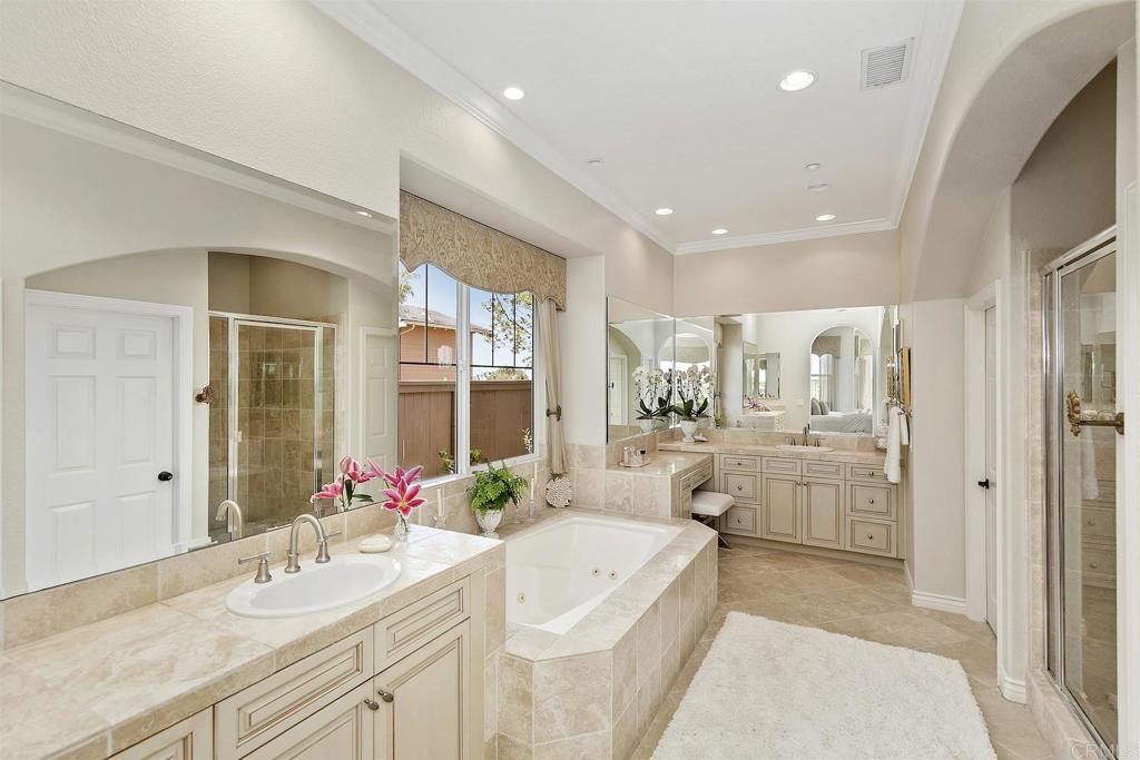 1435 Ravean Court Encinitas, CA 92024 - Photo 29 of 48 a large bathroom with a granite countertop tub a sink and a large mirror