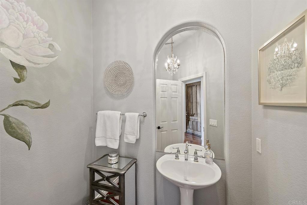 1435 Ravean Court Encinitas, CA 92024 - Photo 34 of 48 a bathroom with a sink mirror and vanity