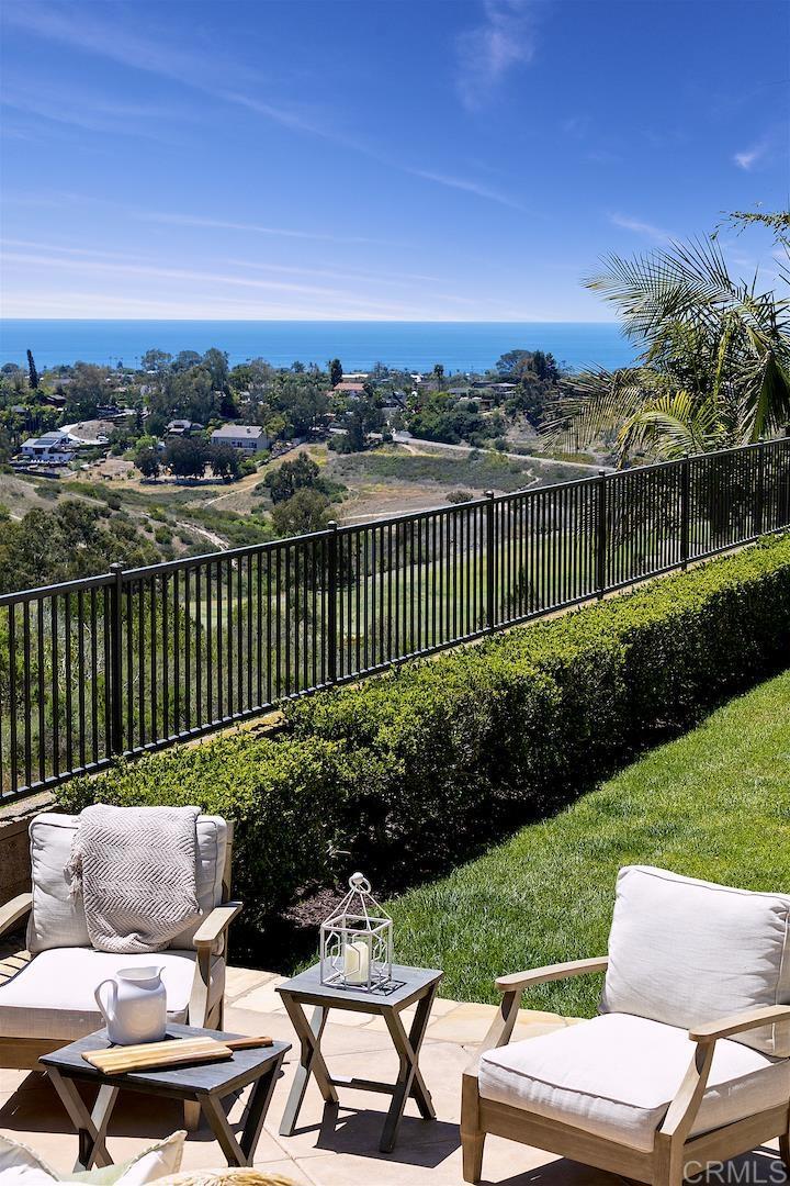 1435 Ravean Court Encinitas, CA 92024 - Photo 48 of 48 a view of a chairs and table in the back yard of a house