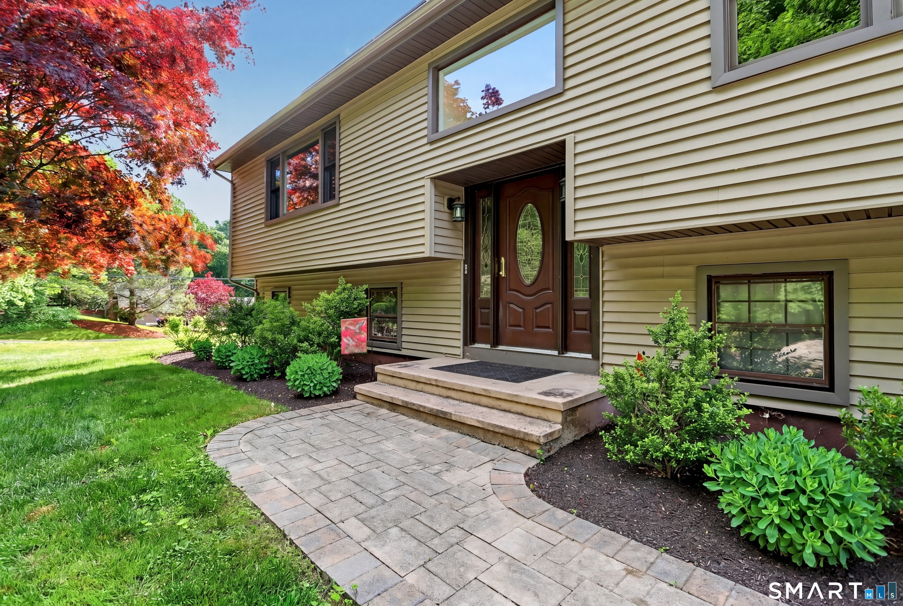 632 Wheelers Farm Road Orange, CT 06477 - Photo 2 of 39 a front view of a house with garden