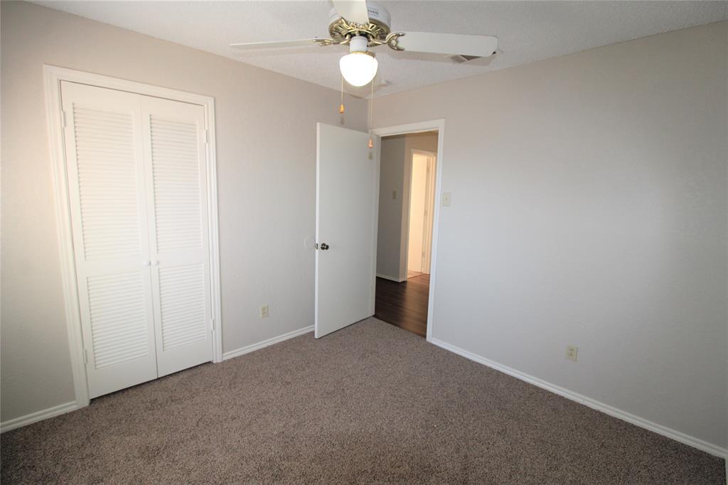 2309 Lakeshore Lane Rowlett, TX 75088 - Photo 12 of 25 an empty room with closet and a chandelier fan