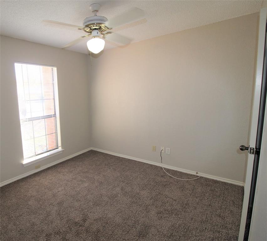 2309 Lakeshore Lane Rowlett, TX 75088 - Photo 13 of 25 an empty room with a window and a fan