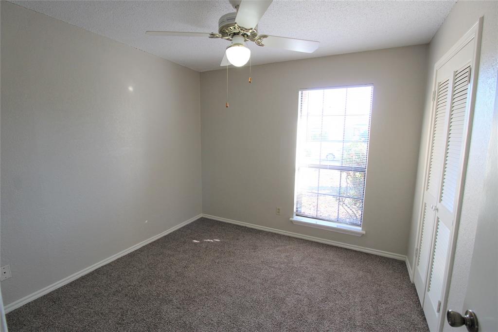2309 Lakeshore Lane Rowlett, TX 75088 - Photo 18 of 25 an empty room with windows and fan