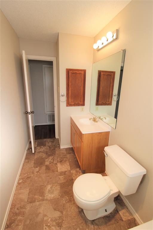 2309 Lakeshore Lane Rowlett, TX 75088 - Photo 20 of 25 a bathroom with a toilet sink and mirror