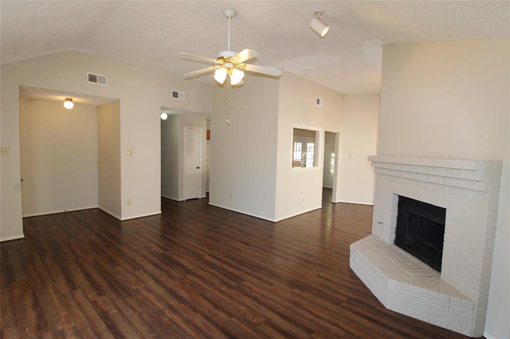 2309 Lakeshore Lane Rowlett, TX 75088 - Photo 3 of 25 a view of an empty room with wooden floor and fireplace