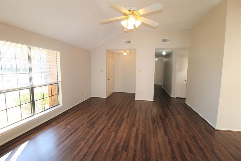 2309 Lakeshore Lane Rowlett, TX 75088 - Photo 4 of 25 an empty room with wooden floor and windows