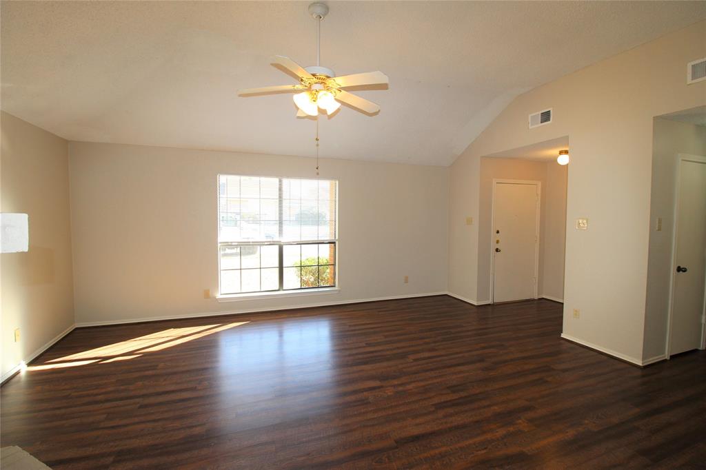 2309 Lakeshore Lane Rowlett, TX 75088 - Photo 5 of 25 a view of an empty room with wooden floor and a window