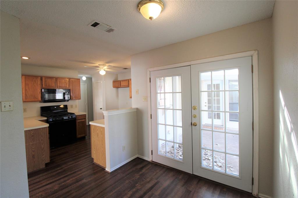 2309 Lakeshore Lane Rowlett, TX 75088 - Photo 7 of 25 a kitchen with a refrigerator and a stove top oven