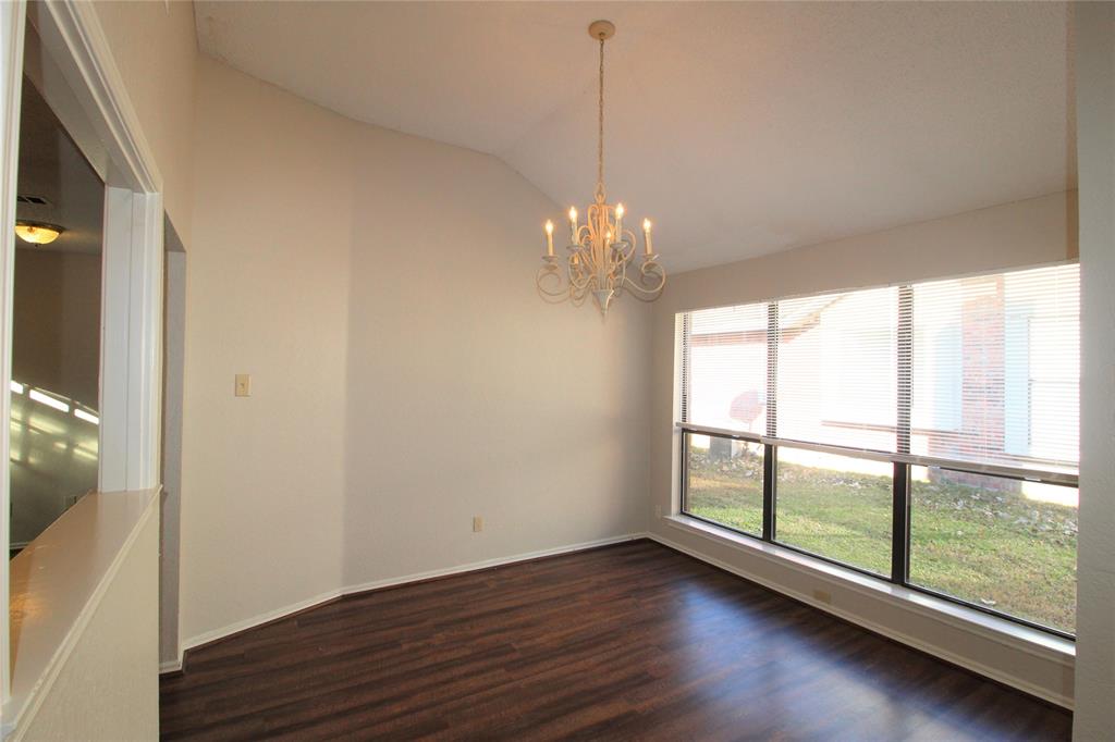 2309 Lakeshore Lane Rowlett, TX 75088 - Photo 8 of 25 a view of a big room with wooden floor chandelier and windows