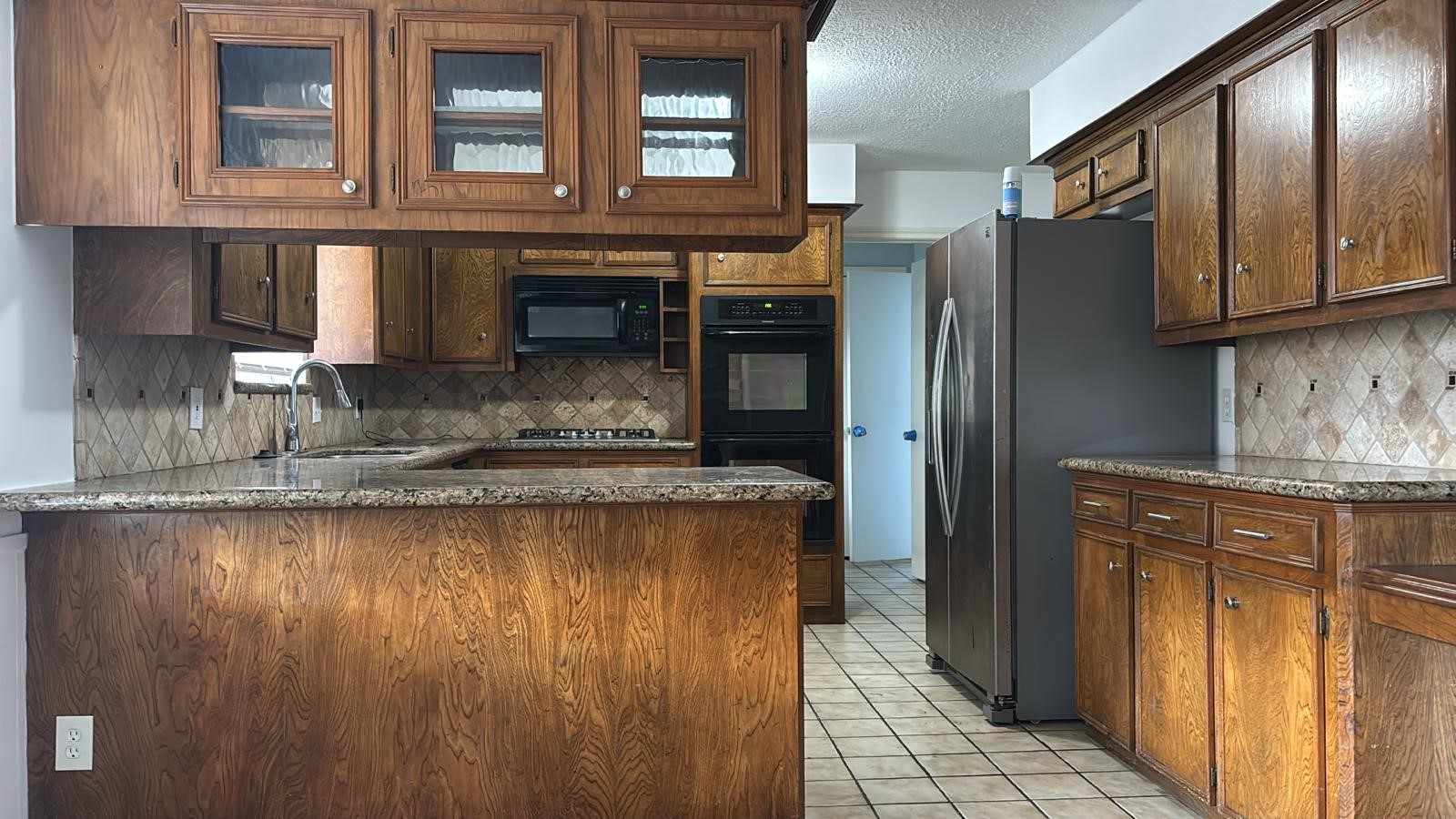 16407 Southampton Drive Spring, TX 77379 - Photo 3 of 12 a kitchen with stainless steel appliances granite countertop a refrigerator and a sink