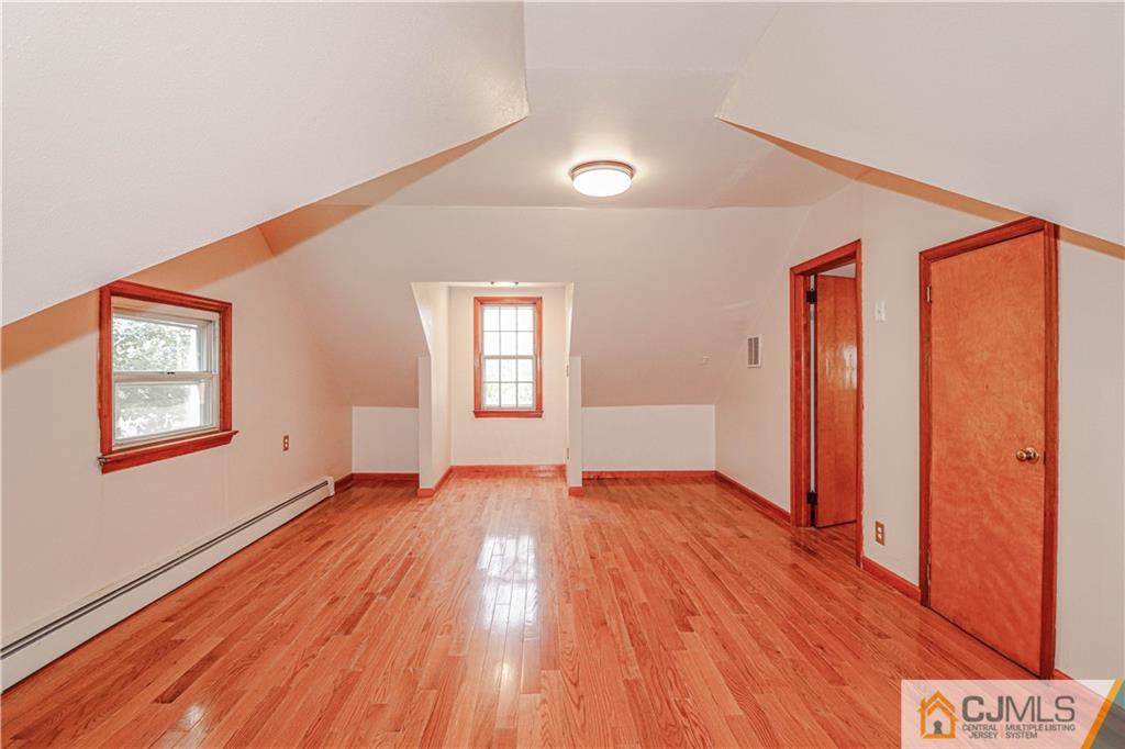 55 3rd Street Edison, NJ 08837 - Photo 12 of 27 an empty room with wooden floor and windows