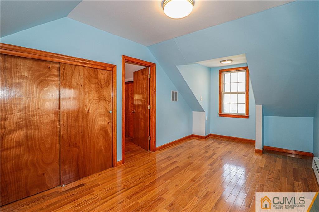 55 3rd Street Edison, NJ 08837 - Photo 14 of 27 a view of an empty room with wooden floor and a window
