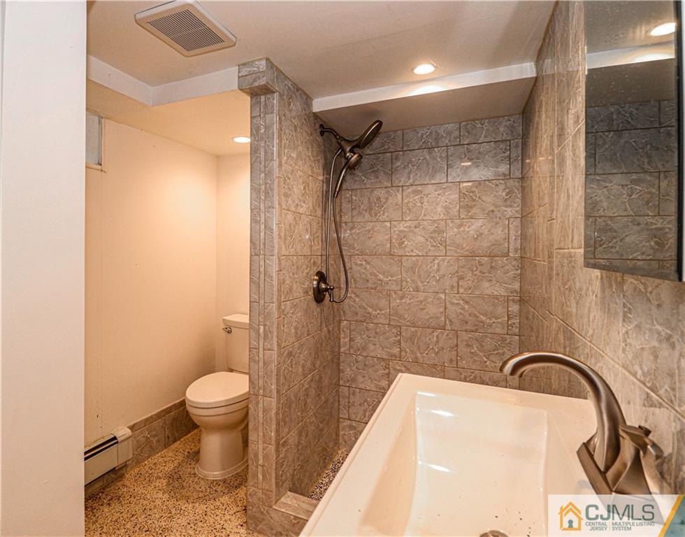 55 3rd Street Edison, NJ 08837 - Photo 16 of 27 a bathroom with a sink a toilet and shower