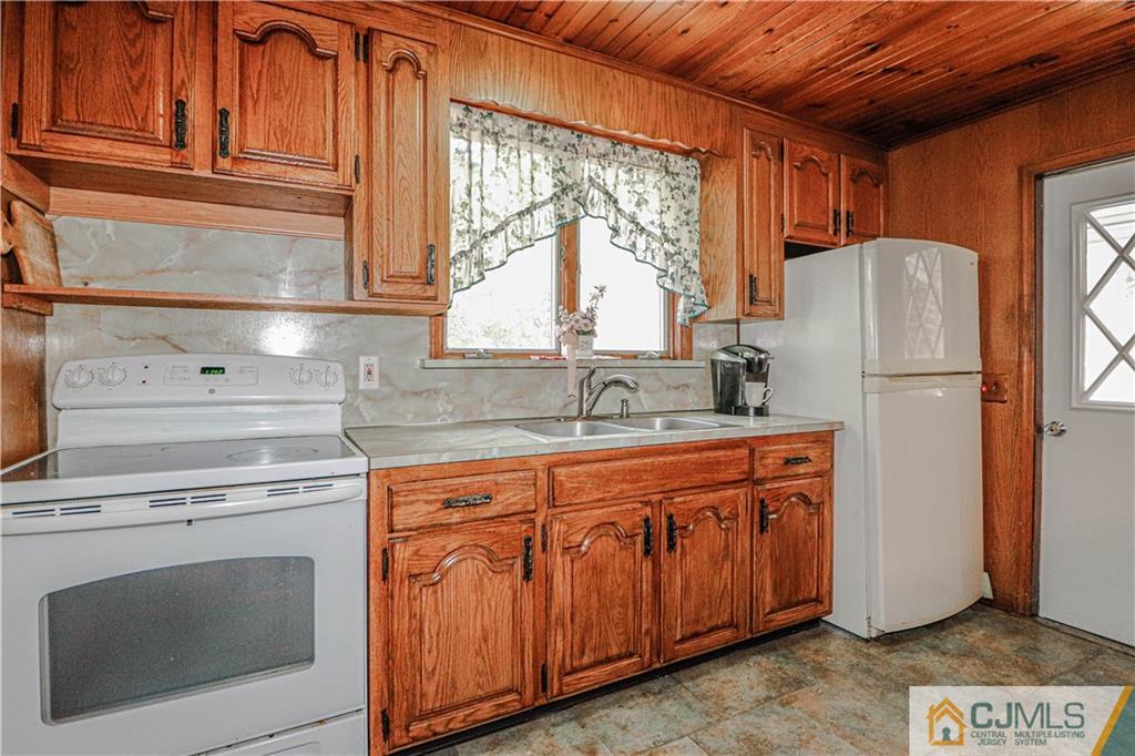 55 3rd Street Edison, NJ 08837 - Photo 5 of 27 a kitchen with stainless steel appliances granite countertop a refrigerator sink and cabinets
