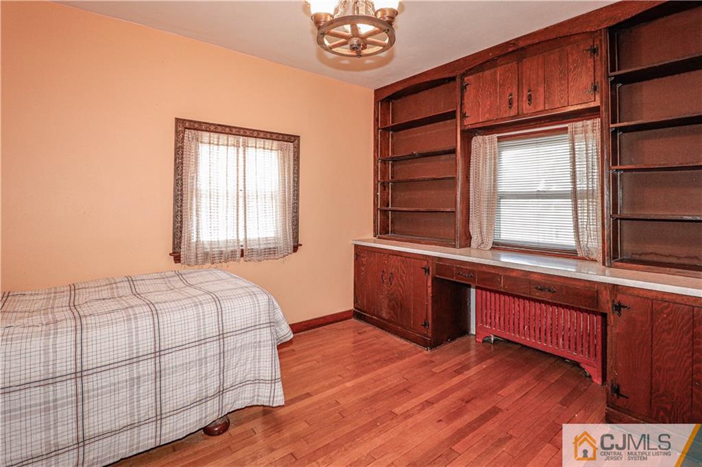 55 3rd Street Edison, NJ 08837 - Photo 8 of 27 a bedroom with a bed and a window with wooden floor