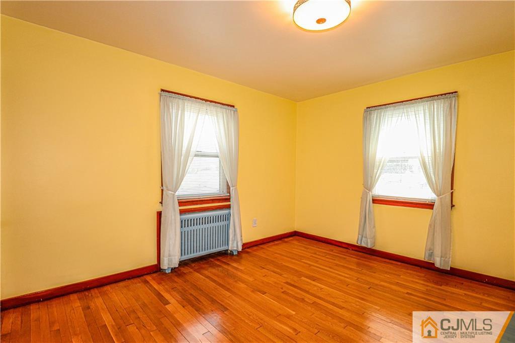 55 3rd Street Edison, NJ 08837 - Photo 10 of 27 a view of an empty room with wooden floor and a window