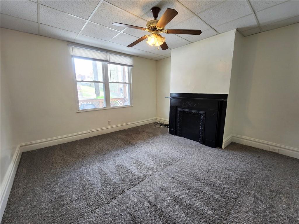 3211 Juliet Street, Unit 1 Pittsburgh, PA 15213 - Photo 3 of 8 an empty room with windows and fireplace