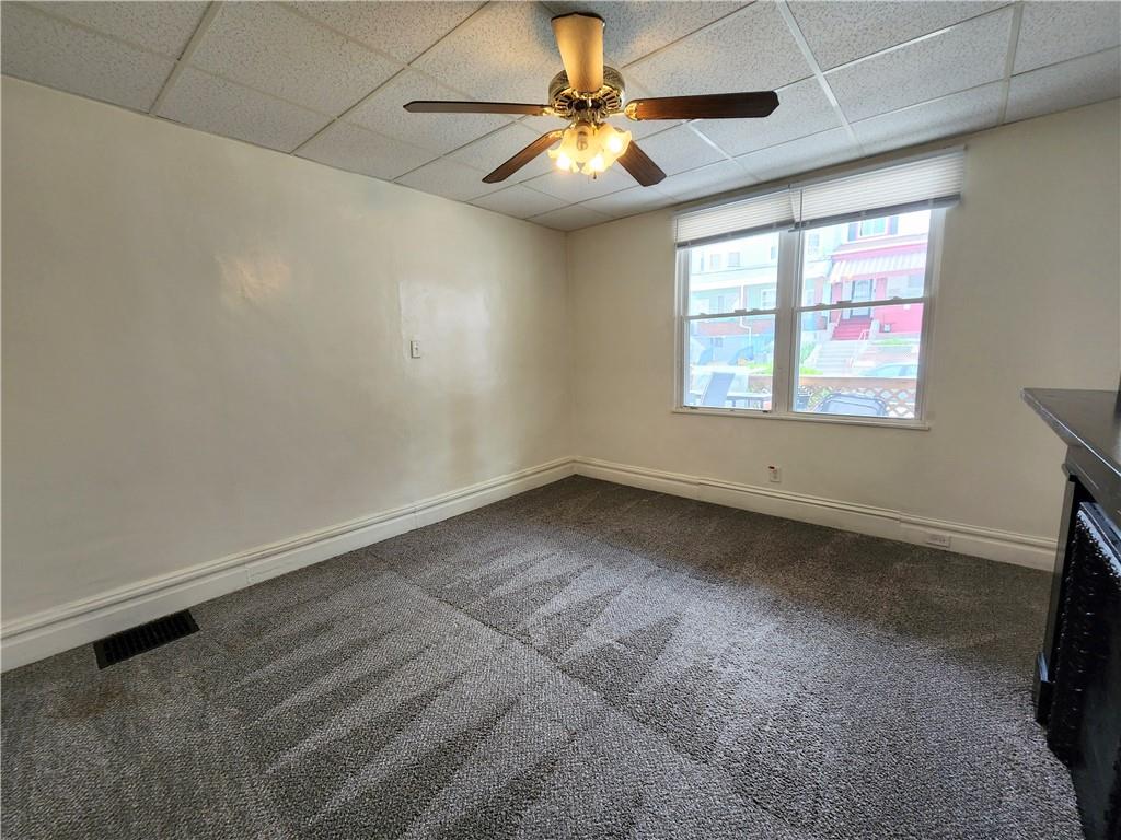 3211 Juliet Street, Unit 1 Pittsburgh, PA 15213 - Photo 4 of 8 an empty room with windows and fan