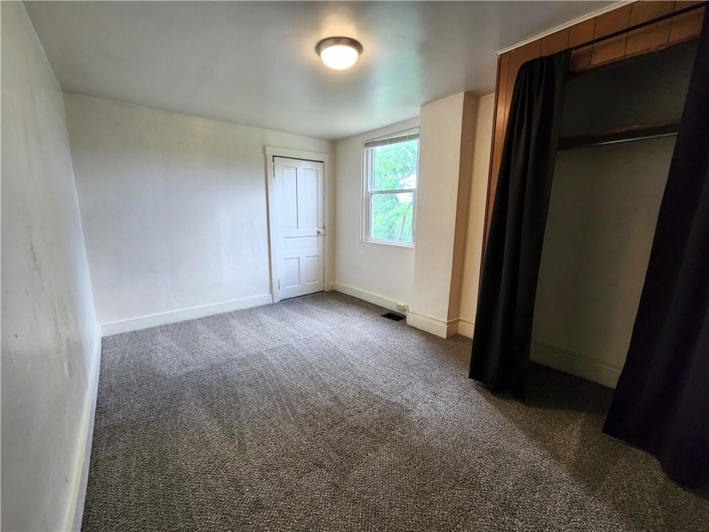 3211 Juliet Street, Unit 1 Pittsburgh, PA 15213 - Photo 8 of 8 an empty room with windows and closet