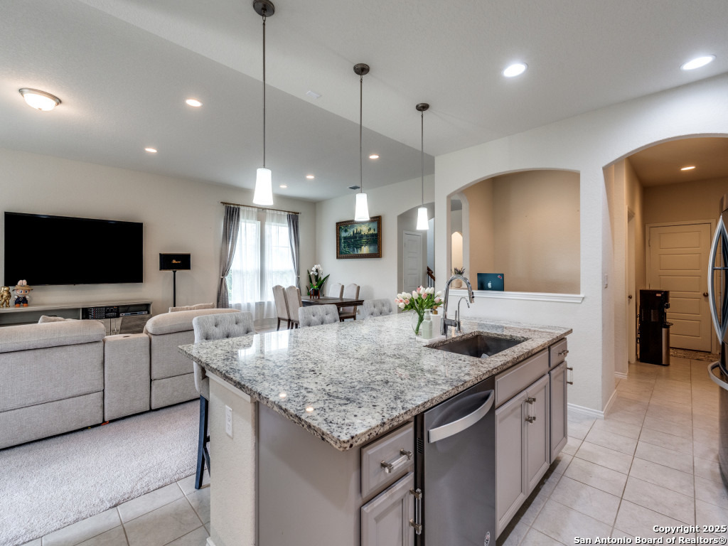 9000 Curling Post Schertz, TX 78154 - Photo 11 of 23 a kitchen with granite countertop a sink and a stove top oven