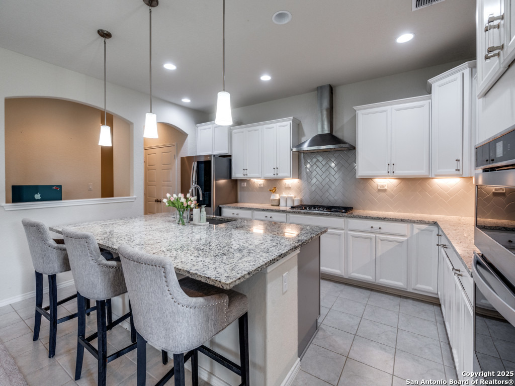 9000 Curling Post Schertz, TX 78154 - Photo 12 of 23 a kitchen with stainless steel appliances granite countertop a stove a sink a oven a dining table and chairs