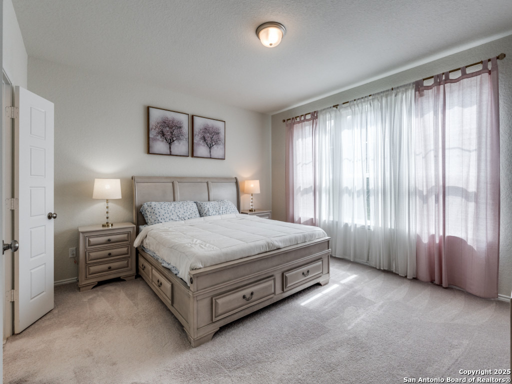 9000 Curling Post Schertz, TX 78154 - Photo 15 of 23 a spacious bedroom with a bed and a window