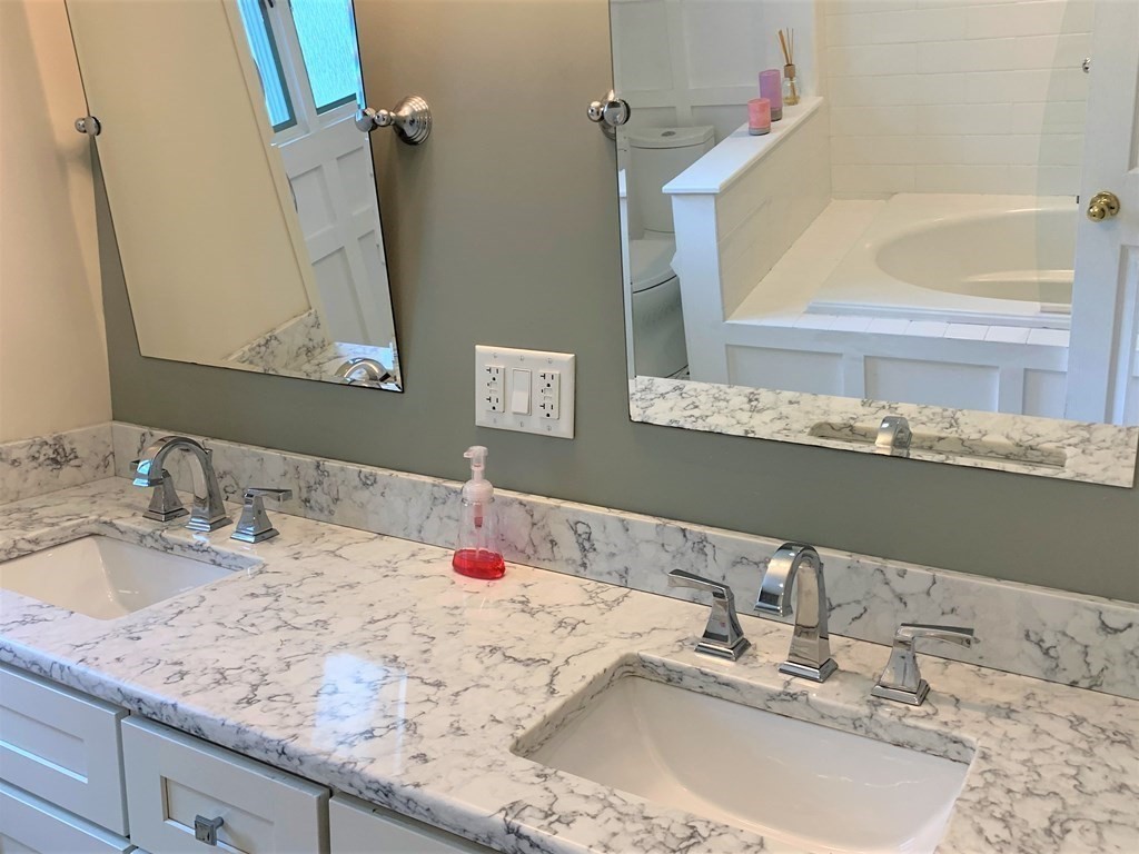 11 Hillcrest Road Salem, NH 03079 - Photo 26 of 42 a bathroom with a granite countertop sink and a mirror