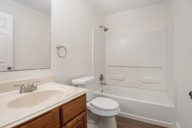 a bathroom with a sink toilet vanity and shower