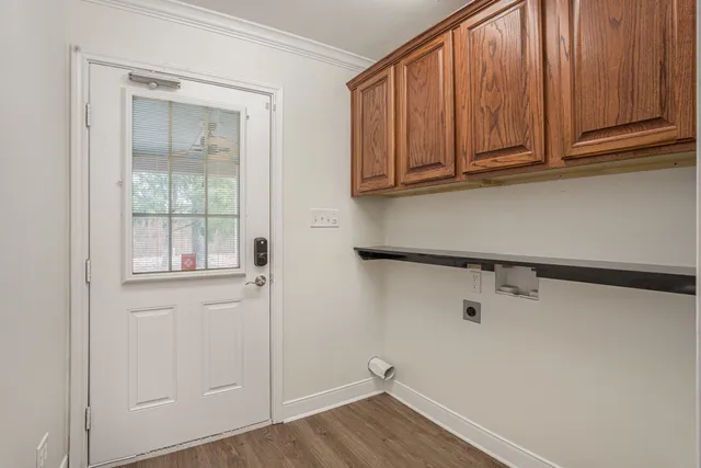 a view of a closet with wooden floor