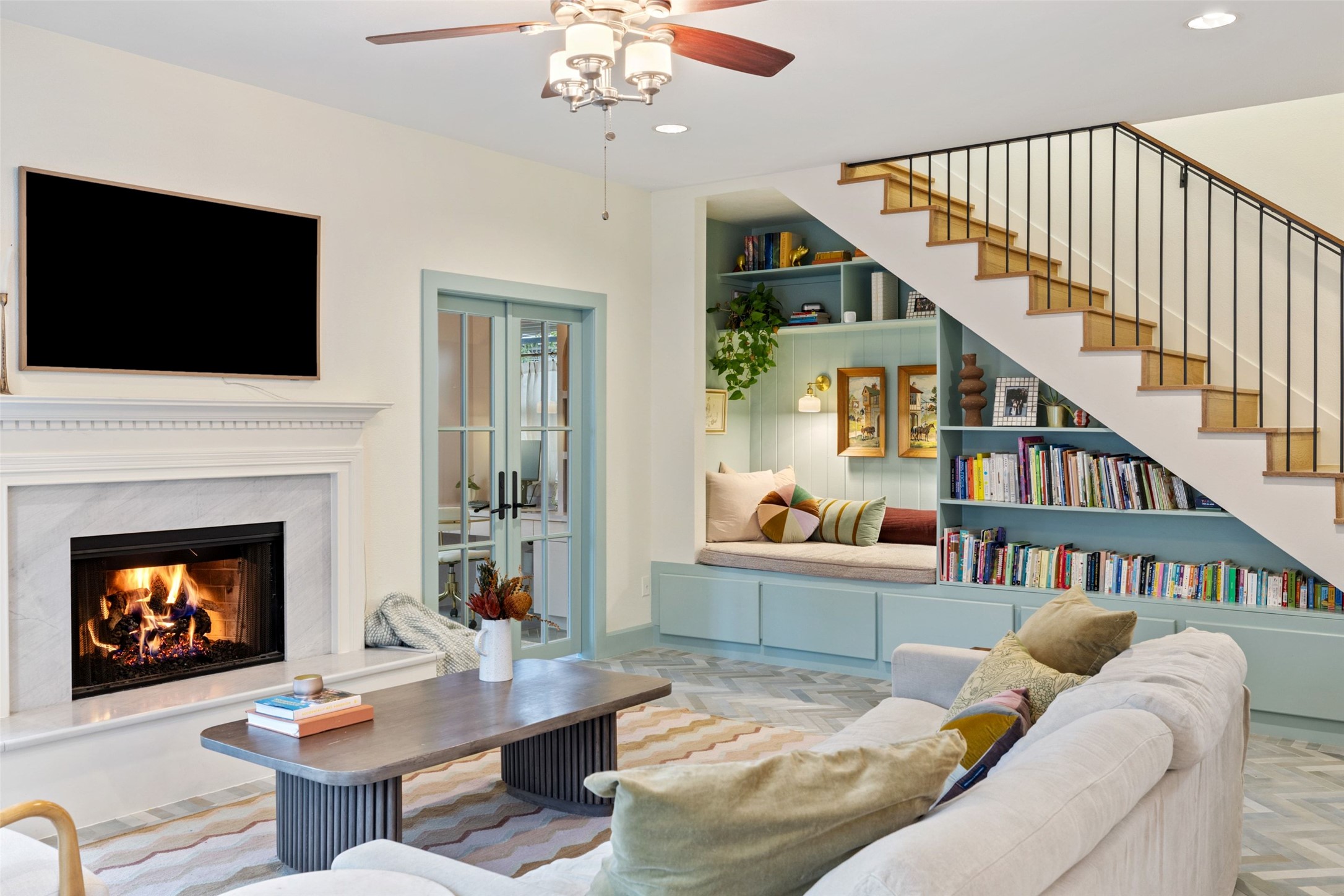 909 East 50th Street Austin, TX 78751 - Photo 1 of 1 a living room with furniture a flat screen tv and a fireplace